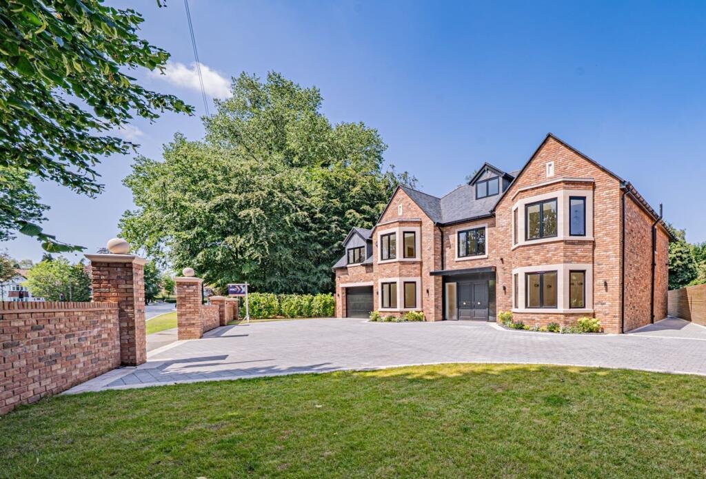 Beautiful family home with brick exterior and well-manicured garden